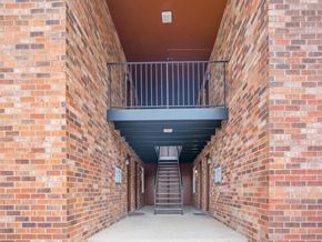 Nashville apartment for rent - a corridor of brick walls with a staircase