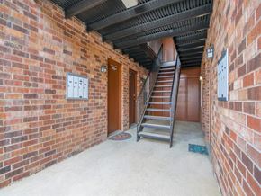 Nashville apartment for rent - an empty brick building with a staircase and a brick wall