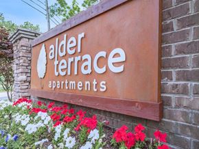 Murfreesboro apartment for rent - a sign for elder terrace apartments with flowers around it