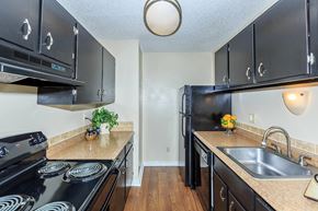 Grandview apartment for rent - A kitchen with black cabinets and a black stove top oven.