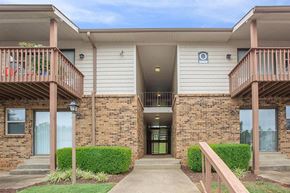 Clarksville apartment for rent - the front entrance of a building with a porch and stairs