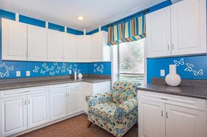 Nashville apartment for rent - a blue and white kitchen with a chair and white cabinets