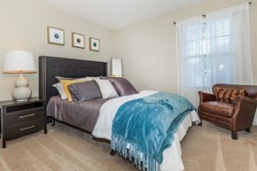 Murfreesboro apartment for rent - a bedroom with a bed and a chair