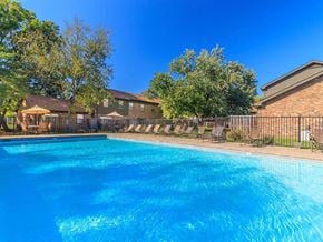 Murfreesboro apartment for rent - a large swimming pool with a building in the background