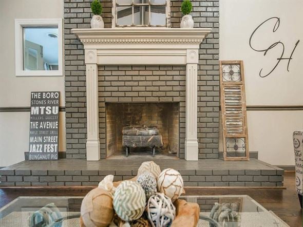 Murfreesboro apartment for rent - a living room with a fireplace and a table with shells on it