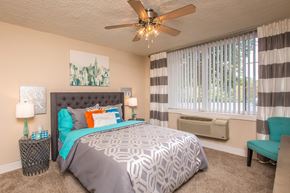 Knoxville apartment for rent - a bedroom with a large bed and a ceiling fan