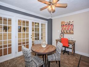 Knoxville apartment for rent - a dining room with a table and chairs and a ceiling fan