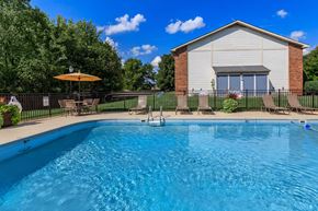 Clarksville apartment for rent - a swimming pool with a house in the background