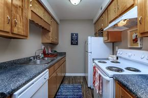 Clarksville apartment for rent - a kitchen with white appliances and granite counter tops