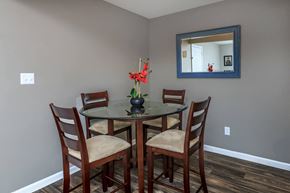Clarksville apartment for rent - a dining room table with four chairs and a mirror