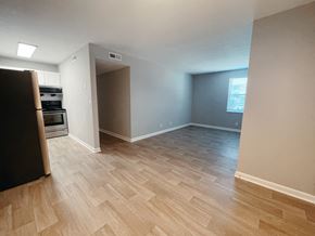 Clarksville apartment for rent - an empty living room and kitchen with wood flooring
