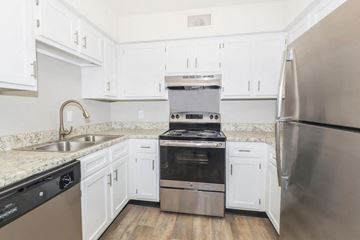 Nashville apartment for rent - a kitchen with white cabinets and stainless steel appliances