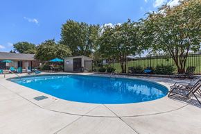 Clarksville apartment for rent - a resort style swimming pool with chairs around it
