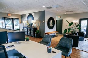 Knoxville apartment for rent - A modern office space with a white desk and black chairs.