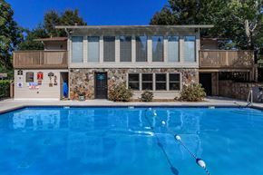 Chattanooga apartment for rent - a house with a large blue pool in front of it