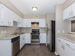 Chattanooga apartment for rent - a kitchen with white cabinets and stainless steel appliances