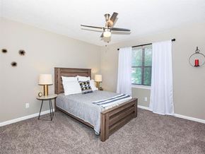 Chattanooga apartment for rent - a bedroom with a bed and a ceiling fan