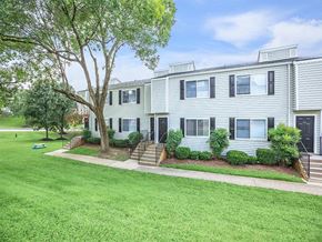 Nashville apartment for rent - a white house with a lawn and trees in front of it