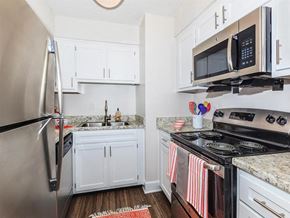 Nashville apartment for rent - a kitchen with stainless steel appliances and white cabinets