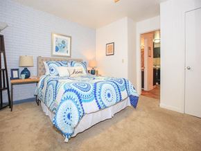 Nashville apartment for rent - a bedroom with a bed and a blue and white comforter