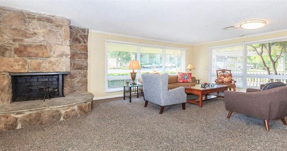 Nashville apartment for rent - a living room with a stone fireplace and furniture