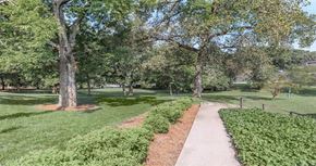 Nashville apartment for rent - a sidewalk in a park with trees and grass