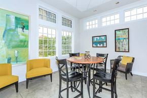 St. Louis townhouse for rent - a dining room with a table and chairs and windows