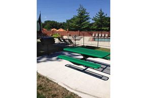 St. Louis townhouse for rent - a green picnic table in front of a swimming pool
