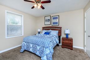 Clarksville apartment for rent - a bedroom with a bed and a ceiling fan