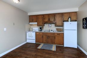 Clarksville apartment for rent - a kitchen with white appliances and wooden cabinets