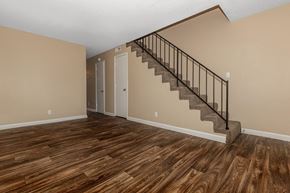 Clarksville apartment for rent - a living room with a staircase and wooden floors