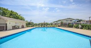 Clarksville apartment for rent - a large blue swimming pool next to a building