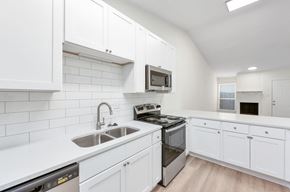 Jackson apartment for rent - A modern kitchen with white cabinets and stainless steel appliances.