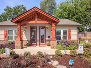 Jackson apartment for rent - the front of a house with a porch and a flower garden