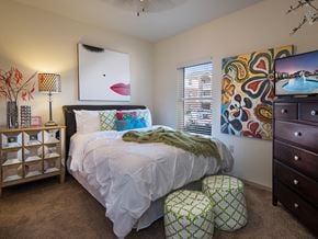 Oklahoma City apartment for rent - a bedroom with a bed and a dresser and a window