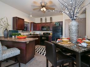 Oklahoma City apartment for rent - a kitchen and dining area with a table and chairs and a ceiling fan