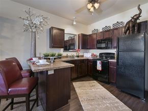 Yukon apartment for rent - a kitchen with a counter top and a refrigerator
