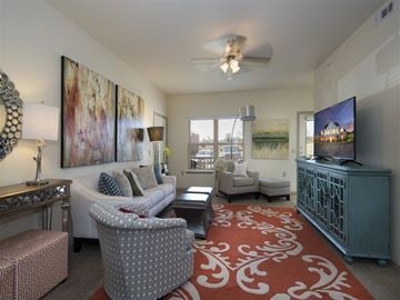 Yukon apartment for rent - a living room filled with furniture and a ceiling fan