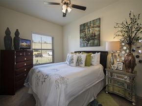 Yukon apartment for rent - a bedroom with a bed and a ceiling fan