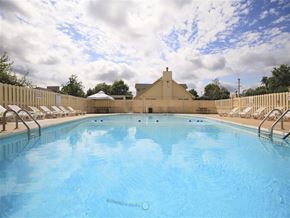 Fort Smith apartment for rent - a large pool with chairs and a fence around it