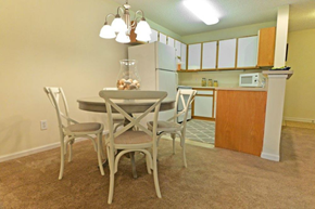 Wilmington apartment for rent - a kitchen with a table and chairs and a refrigerator