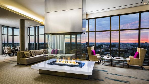 Reston apartment for rent - a living room with a fireplace and a view of the city