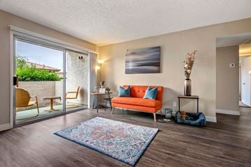 Phoenix apartment for rent - a living room with an orange couch and a sliding glass door
