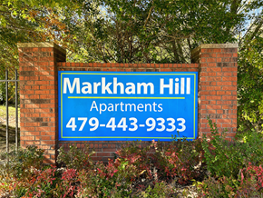 Fayetteville apartment for rent - a blue and white sign on a brick wall