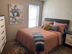 Fayetteville apartment for rent - a bedroom with a bed and a painting on the wall