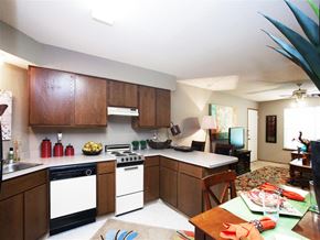 Fayetteville apartment for rent - a kitchen with white appliances and wooden cabinets