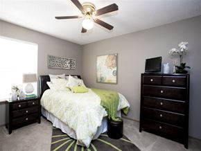 Fayetteville apartment for rent - a bedroom with a bed and a ceiling fan