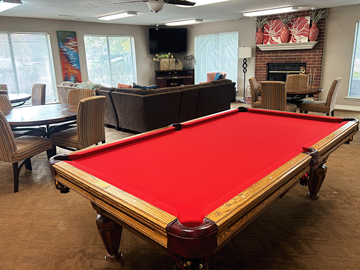 Fayetteville apartment for rent - a pool table in a living room with a red pool