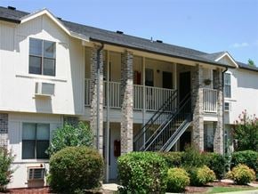 Fayetteville apartment for rent - the front of an apartment building with a porch and stairs
