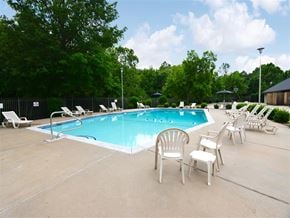 Fayetteville apartment for rent - a swimming pool with chairs and chairs around it